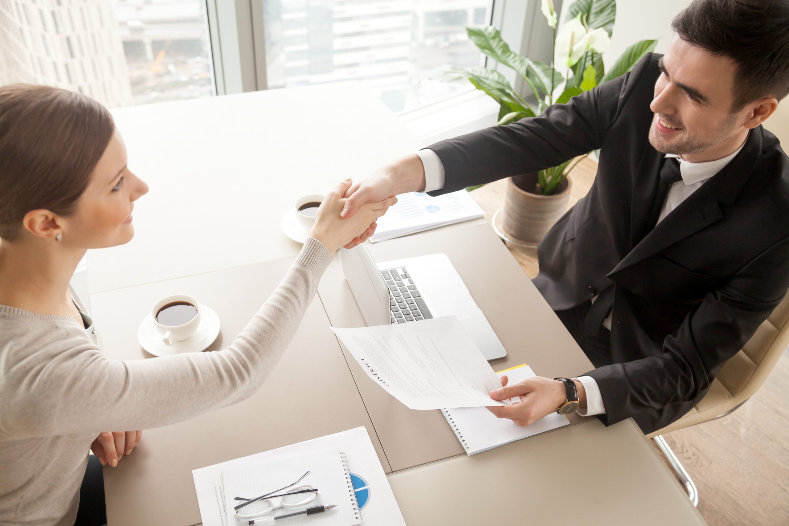 business partners celebrating contract signing scaled