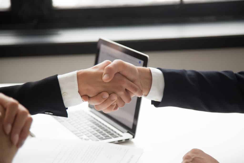 businessman handshaking businesswoman showing respect closeup view of hands shaking