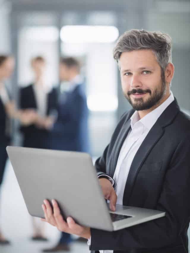 cropped businessman using laptop