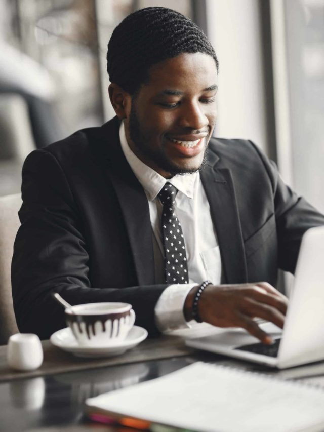 cropped african american businessman using a laptop in a cafe scaled 1