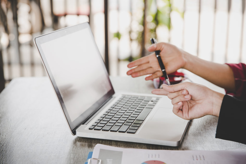 business analysis concept businesswoman analyzing business documents finacial report working laptop computer mobile smart phone office desk close up