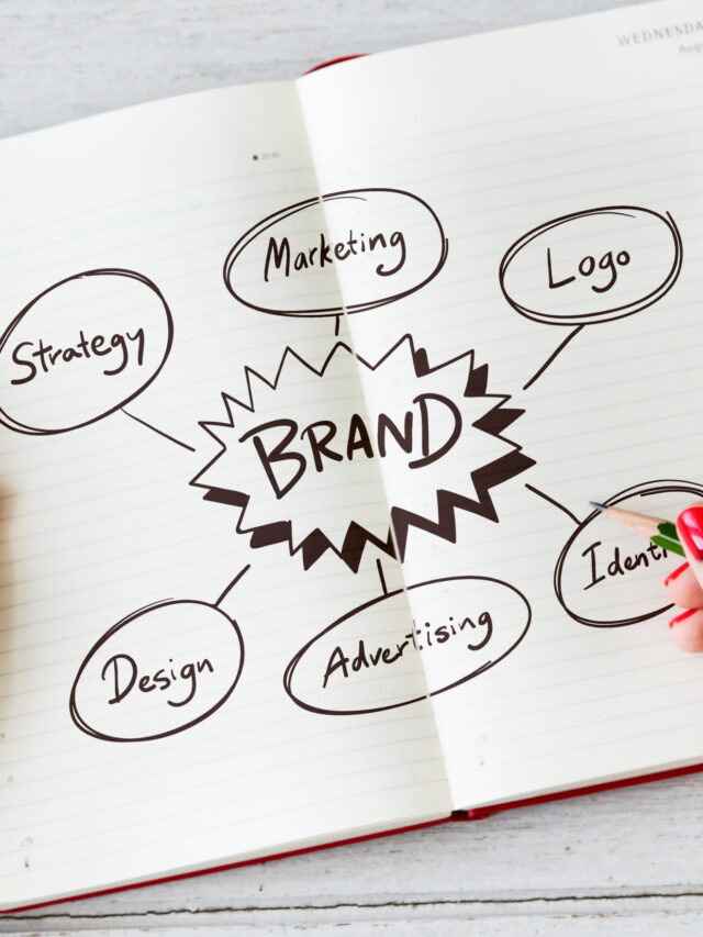 Young woman drawing brand in a notebook