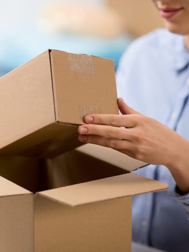 woman packing parcel box at post office