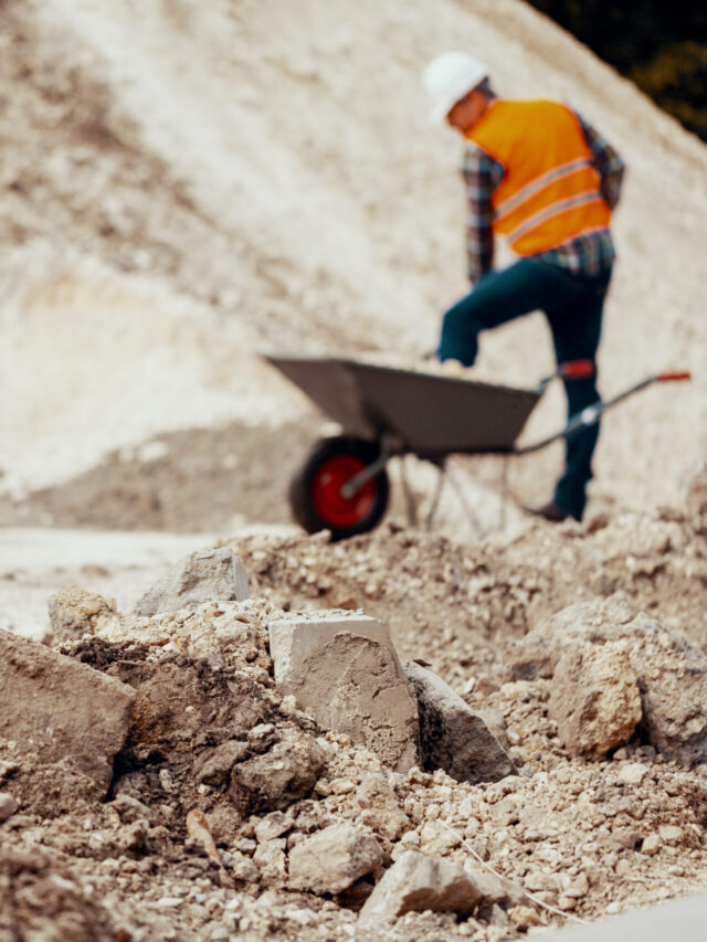 Worker in reflective vest and white helmet during physical work