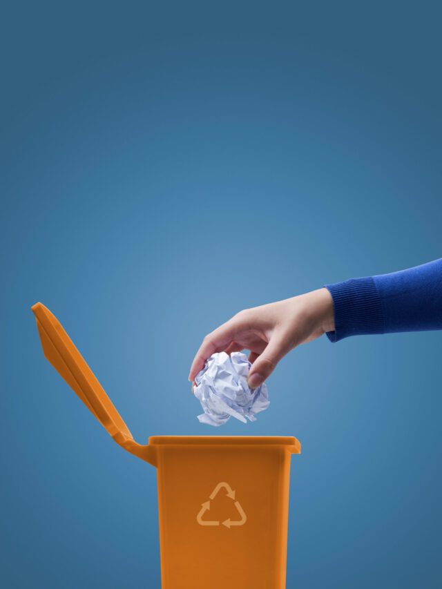 Woman putting paper in the trash bin