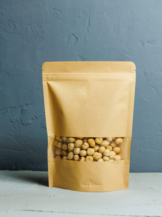 Roasted hazelnuts in a paper kraft bag. Delicious peanuts.