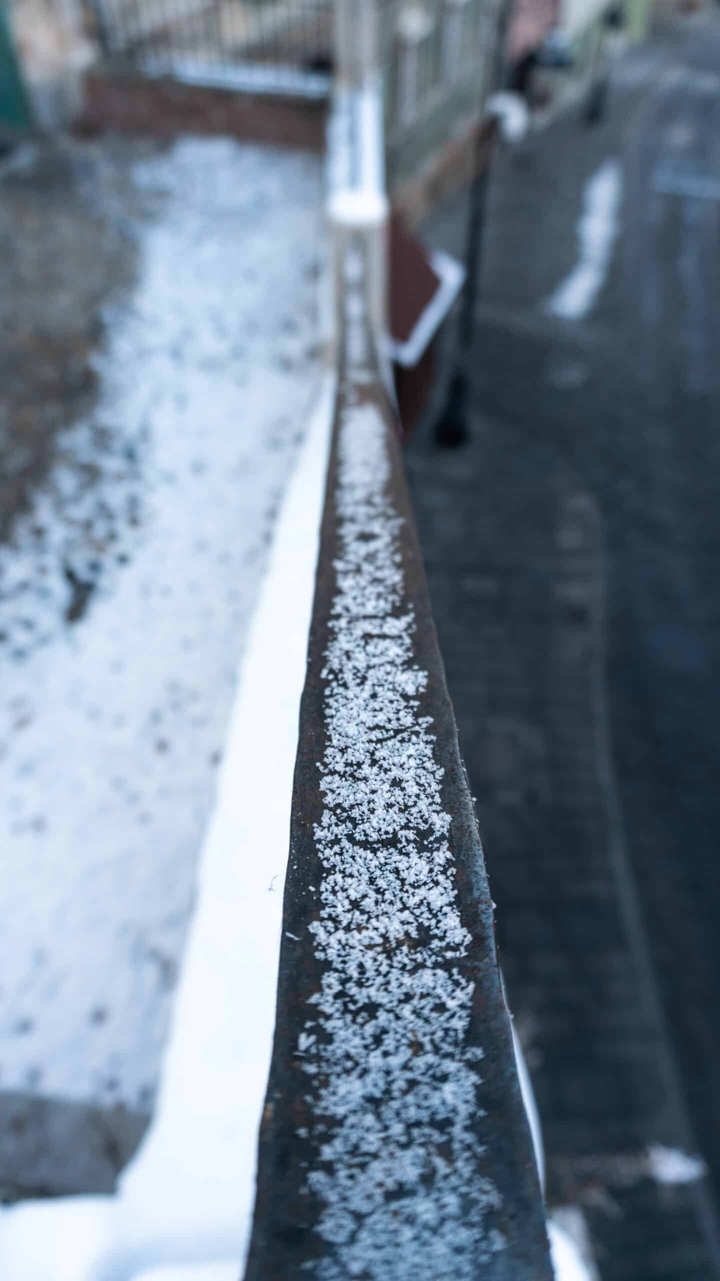 vertical selective focus shot snow railing sibiu romania scaled