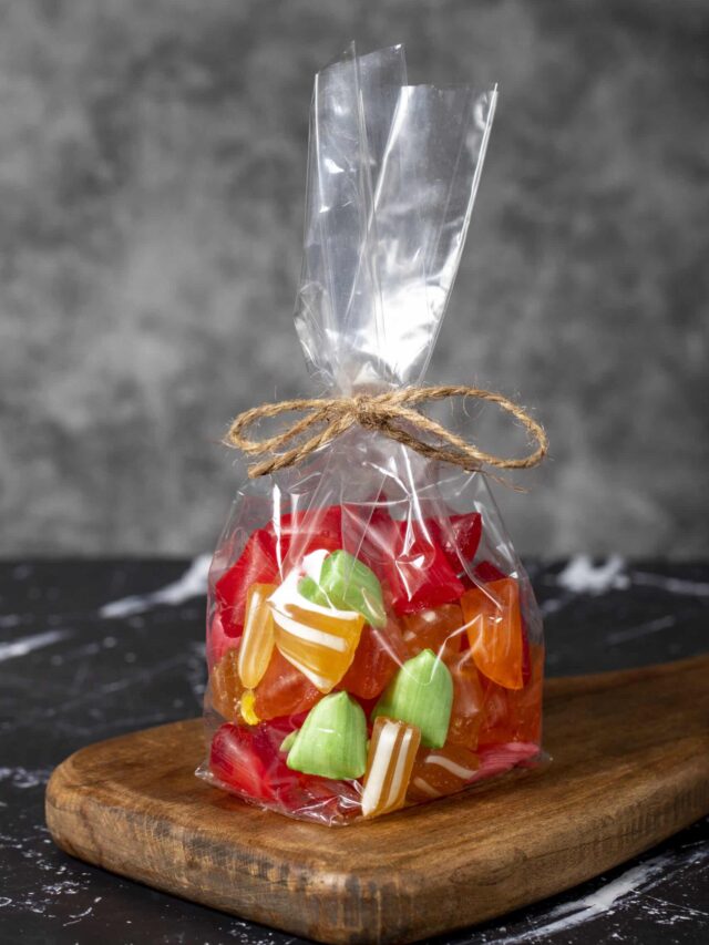 Fruit drops. Packed fruit flavored candy on a dark background