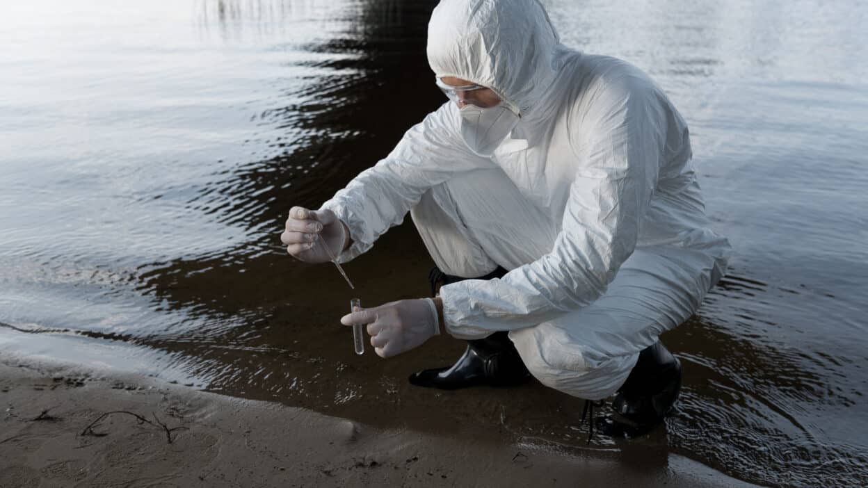 water inspector protective costume respirator taking water sample river