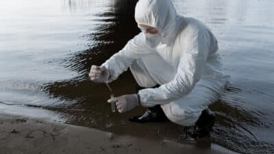 water inspector protective costume respirator taking water sample river